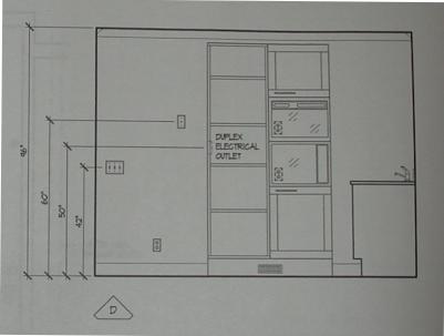 The cabinet containing the steam and microwave ovens